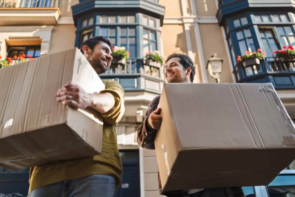 Two men carrying boxes