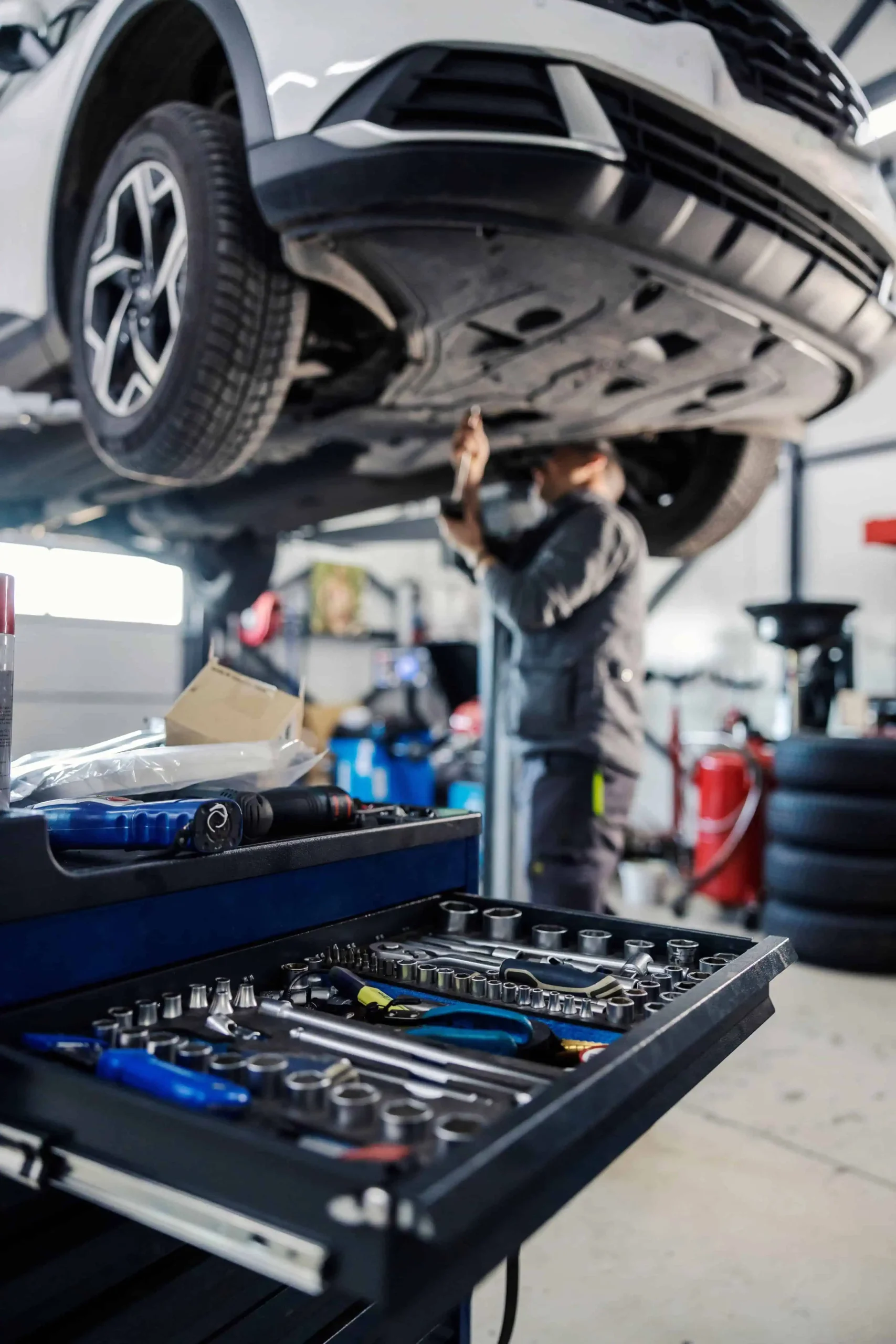 Mechanic working on car on a lift