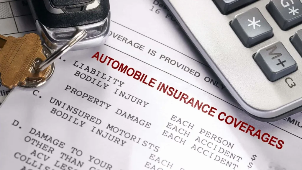 Insurance document, calculator and car key fob