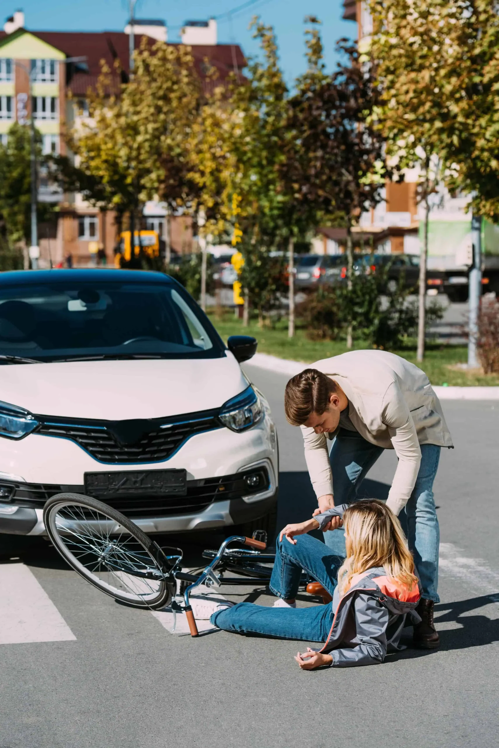 Man helping woman up from the road